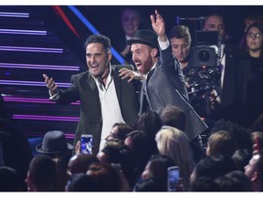 Jorge Drexler, left, and Jesus Martos react in the audience as Drexler is announced winner of the award for record of the year for "Telefonia" at the Latin Grammy Awards on Thursday, Nov. 15, 2018, at the MGM Grand Garden Arena in Las Vegas.