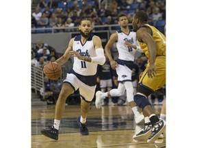Nevada Cody Martin (11) brings the ball up the floor against California Baptist in the first half of an NCAA college basketball game in Reno, Nev., Monday, Nov. 19, 2018.