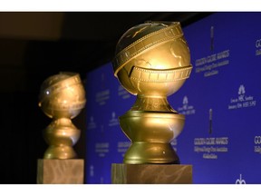 FILE - In this Jan. 10, 2016 file photo, Golden Globe statues appear at the 73rd annual Golden Globe Awards nominations at the Beverly Hilton hotel  in Beverly Hills, Calif.  The Hollywood Foreign Press Association is giving $300,000 to help the victims of California's wildfires and their families. The organization best known as the creators and organizers of the Golden Globe Awards on Thursday, Nov. 15, 2018 announced the donation to four organizations that also include money for victims and families of last week's mass shooting in Southern California.