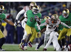 FILE - In this Saturday, Nov. 10, 2018 file photo, Notre Dame running back Dexter Williams (2) runs for a touchdown against Florida State in the second half of an NCAA college football game in South Bend, Ind. Senior Dexter Williams has been through countless ups and downs during his four years at Notre Dame. Injury, suspension, an arrest, the emotions of helping his ailing mother all of it has weighed down Williams at times. He has emerged just the same as the workhorse running back for the third-ranked Fighting Irish, and a key reason Notre Dame has legitimate hopes of making the playoff.