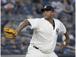 FILE - In this Wednesday, Aug. 29, 2018 file photo, New York Yankees starting pitcher CC Sabathia delivers the ball to the Chicago White Sox during the second inning of a baseball game at Yankee Stadium in New York. A person familiar with the negotiations says CC Sabathia is staying with the New York Yankees for an 11th season, agreeing to an $8 million, one-year contract. The person spoke on condition of anonymity Tuesday, Nov. 6, 2018 because the agreement is subject to a successful physical.