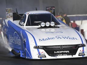 This photo provided by the NHRA, Funny Car racer Tommy Johnson Jr. races to the qualifying lead at the 54th annual Auto Club NHRA Finals at Auto Club Raceway, Friday, Nov. 9, 2018 in Pomona, Calif. Two-time defending event champion Johnson Jr.'s second qualifying run of 3.881 at 328.54 in his Dodge Charger R/T locked-in the top spot. .