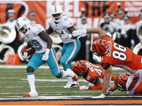 FILE - In this Oct. 7, 2018, file photo, Miami Dolphins' Jakeem Grant (19) returns a punt by the Cincinnati Bengals for a touchdown during the first half of an NFL football game in Cincinnati. Grant beat out Kansas City's Tyreek Hill as the NFL's top returner in 2018 in voting released Friday by a panel of 10 football writers for The Associated Press.