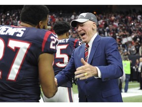 FILE - In this Jan. 3, 2016, file photo, Houston Texans owner Robert "Bob" McNair, right, greets players after the team's win over Jacksonville Jaguars in an NFL football game in Houston. McNair, billionaire founder and owner of the Texans, has died. He was 81. One of the NFL's most influential owners, McNair had battled both leukemia and squamous cell carcinoma in recent years before dying in Houston on Friday, Nov. 23, 2018.