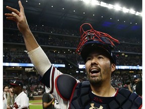 FILE - In this Oct. 7, 2018, file photo, Atlanta Braves catcher Kurt Suzuki celebrates after Game 3 of baseball's National League Division Series against the Los Angeles Dodgers, in Atlanta. Catcher Kurt Suzuki is heading back to the Washington Nationals after agreeing to a $10 million, two-year contract, a deal pending a successful physical. The deal was disclosed to The Associated Press on Monday, Nov. 19, 2018, by a person familiar with the agreement who spoke on condition of anonymity because the contract was not yet official.