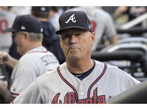 FILE - In this Friday, Aug. 3, 2018 file photo, Atlanta Braves manager Brian Snitker looks on from the dugout before a baseball game against the New York Mets in New York. Atlanta's Brian Snitker has been voted National League Manager of the Year after leading the Braves to a surprising first-place finish. Snitker received 17 first-place votes, nine seconds and one third for 116 points from the Baseball Writers' Association of America in balloting announced Tuesday, Nov. 13, 2018.