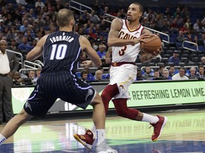 FILE - In this Nov. 5, 2018, file photo, Cleveland Cavaliers' George Hill (3) drives to the basket against Orlando Magic's Evan Fournier (10) during the first half of an NBA basketball game in Orlando, Fla. A person familiar with the situation says Hill will miss at least two weeks with a shoulder injury. Hill, who was kept out of Wednesday's loss to Oklahoma City due to soreness, has a sprained shoulder, said the person who spoke to The Associated Press on condition of anonymity because the team has not yet provided an update on the veteran guard's condition.