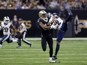 FILE - In this Nov. 4, 2018, file photo, New Orleans Saints wide receiver Michael Thomas (13) pulls in a pass against Los Angeles Rams cornerback Marcus Peters (22) during the first half of an NFL football game in New Orleans. Peters criticized himself for playing poorly when the Rams took their first loss of the season at New Orleans last weekend. That doesn't mean Saints coach Sean Payton can say anything about it, however. Peters reacted sharply in the Rams' locker room Thursday, Nov. 8, when asked about postgame comments by Payton in which the veteran coach said the Saints liked the matchup of receiver Michael Thomas going against Peters, a former Pro Bowl selection.