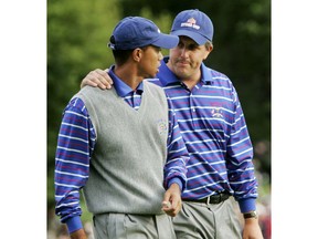 FILE - In this Sept. 17, 2004, file photo, U.S. team player Phil Mickelson puts his arm around partner Tiger Woods as they walk off the 18th green after they lost to Europeans Darren Clarke and Lee Westwood on the final hole of their foursomes match at the 35th Ryder Cup at Oakland Hills Country Club in Bloomfield Township, Mich. They play a high-stakes exhibition Friday in Las Vegas in golf's first venture using pay-per-view.