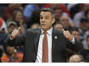 FILE - In this Friday, March 16, 2018 file photo, Virginia coach Tony Bennett signals for a jump ball during the first half of the team's first-round game against UMBC in the NCAA men's college basketball tournament in Charlotte, N.C. Bennett's fourth-ranked Cavaliers are the highest-ranked team at this week's Battle 4 Atlantis in the Bahamas.