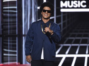 FILE - In this May 20, 2018, file photo, Bruno Mars presents the Icon award at the Billboard Music Awards at the MGM Grand Garden Arena in Las Vegas. Mars will mark the end of his massive "24K Magic World Tour" by providing meals to 24,000 Hawaii residents in need for the Thanksgiving holiday. The singer, who was born and raised in Honolulu, Hawaii, announced Sunday, Nov. 11, he has donated money to the Salvation Army's Hawaiian and Pacific Islands Division, which holds an annual Thanksgiving meal program to help those in need.