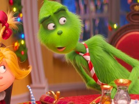 FILE - This file image released by Universal Pictures shows the characters Cindy-Lou Who, voiced by Cameron Seely, left, and Grinch, voiced by Benedict Cumberbatch, in a scene from "The Grinch." "Dr. Seuss' The Grinch" made off with $66 million for Universal Pictures to top the weekend North American box office, according to studio estimates Sunday, Nov 11, 2018.