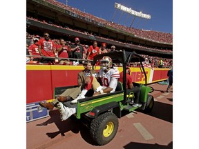 FILE - In this Sept. 23, 2018 file photo, San Francisco 49ers quarterback Jimmy Garoppolo (10) is carted off the field after being injured during the second half of an NFL football game against the Kansas City Chiefs, in Kansas City, Mo. Trying to pick up an extra yard on Sept. 23 cost Garoppolo the rest of this season with a torn left ACL when his leg buckled underneath him. He was hurt in the fourth quarter of a 38-27 loss to Kansas City after trying to cut up field instead of going out of bounds. That gave the 49ers only three games with the quarterback they signed to a $137.5 million, five-year contract after he won five straight games to wrap up last season.