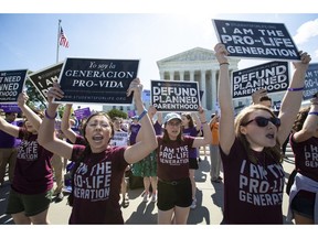 FILE - In this June 25, 2018 file photo, pro-life and anti-abortion advocates demonstrate in front of the Supreme Court. On Wednesday, Nov. 28, 2018, representatives of several national anti-abortion groups met with administration staffers at the White House to discuss how President Donald Trump _ who has supported their agenda _ could continue to be helpful in the changed political circumstances.