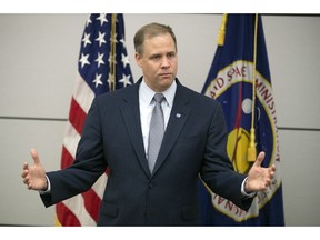 FILE - In this Oct. 12, 2018 file photo, Administrator of the National Aeronautics and Space Administration (NASA) Jim Bridenstine speaks during a news conference at the U.S. Embassy in Moscow, Russia. America's next moon landing will be made by private companies, not NASA. Bridenstine announced Thursday, Nov. 29 that nine U.S. companies will compete in delivering experiments to the lunar surface.