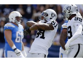 FILE- In this Oct. 7, 2018, file photo, Oakland Raiders defensive end Bruce Irvin, center, reacts after sacking Los Angeles Chargers quarterback Philip Rivers during the first half of an NFL football game in Carson, Calif.  The Atlanta Falcons have signed Irvin to a one-year deal announced Wednesday, Nov. 7, 2018, reuniting the veteran with coach Dan Quinn. Irvin, cut by the Oakland Raiders on Saturday, became a free agent after clearing waivers on Tuesday with $3.8 million remaining on his contract.