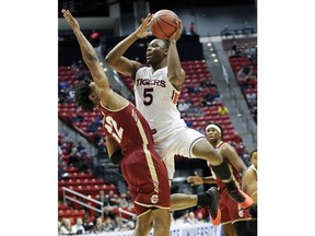 FILE - In this March 16, 2018, file photo, Auburn guard Mustapha Heron (5) shoots as Charleston guard Cameron Johnson (12) defends during the first half of a first-round NCAA college basketball tournament game in San Diego. Heron received an NCAA waiver enabling him to play for St. John's immediately rather than sitting out a year.