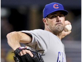 FILE- In this Aug. 17, 2018, file photo, Chicago Cubs starter Cole Hamels pitches to a Pittsburgh Pirates batter during the first inning of a baseball game in Pittsburgh. The Cubs face a decision on Hamels' option on Friday, Nov. 2,2018, as baseball teams decide whether to make $17.9 million qualifying offers to their eligible former players