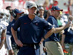 FILE - In this Sept. 29, 2018, file photo, Virginia head coach Bronco Mendenhall watches the action during the second half of an NCAA college football game in Raleigh, N.C. If first-place Pitt or second-place Virginia goes on to win the Coastal title this season, either would become the sixth different school in the last six seasons to win that side of the conference