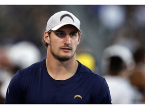 FILE - In this Aug. 25, 2018, file photo, Los Angeles Chargers defensive end Joey Bosa watches from the sideline during the second half of an NFL preseason football game against the New Orleans Saints in Carson, Calif.  Bosa practiced for the first time in two months on Wednesday, Nov. 14, 2018, as he tries to come back from a foot injury.