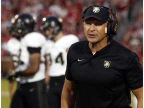 FILE- In this Sept. 22, 2018, file photo, Army head coach Jeff Monken shouts in the first half of an NCAA college football game against Oklahoma in Norman, Okla. For all the complaints about too many bowls, this is the second straight season there will be more bowl eligible teams (at least 81) than available bids (78). That has put No. 23 Army and fellow football independent BYU (6-6), another school with a large national following, in the strange position of tracking results from all over the country in recent weeks and heading into college football's selection Sunday with postseason plans more uncertain than most.
