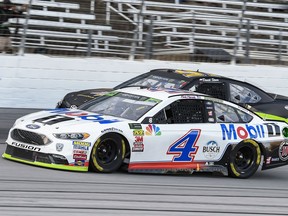 FILE - In this Sunday, Nov. 4, 2018, file photo, Kevin Harvick (4) passes David Starr (97)  during the NASCAR Cup auto race at Texas Motor Speedway in Fort Worth, Texas. Harvick's bid for a second NASCAR title suffered a massive setback when he was stripped of his berth in the championship race after series inspectors found his winning car from Texas Motor Speedway had been deliberately altered to give him a performance advantage.