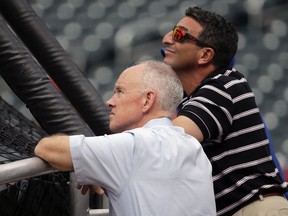 FILE - In this Aug. 10, 2015, file photo, New York Mets general manager Sandy Alderson, left, and his special assistant, J.P. Ricciardi, watch batting practice before a baseball game in New York. Ricciardi is leaving the New York Mets after eight seasons.