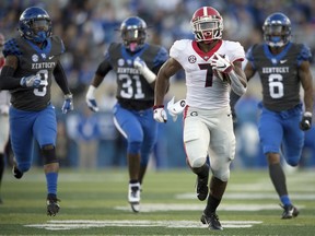 FILE - In this Saturday, Nov. 3, 2018, file photo, Georgia running back D'Andre Swift (7) runs for a touchdown during the second half an NCAA college football game against Kentucky in Lexington, Ky. The Bulldogs have produced dynamic running backs over the years, from Herschel Walker to Todd Gurley. The trend continues this season with Holyfield and D'Andre Swift.