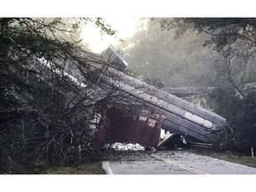 The exact number of cars involved is unclear. CSX says "several" cars derailed. The town's fire chief, Brett Walls, tells WMAZ-TV that between 15 and 30 cars fell from a bridge onto Georgia Highway 90.    (Montezuma police via AP)