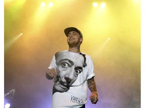 FILE - In this July 13, 2013, file photo, Rapper Mac Miller performs on his Space Migration Tour at Festival Pier in Philadelphia. A Los Angeles County coroner's report released Monday, Nov. 5, 2018, named the 26-year-old Miller's cause of death as "mixed toxicity," saying cocaine, alcohol and the powerful opioid fentanyl were found in his system. Paramedics found Miller unresponsive in his Los Angeles home on Sept. 7 and declared him dead soon after.