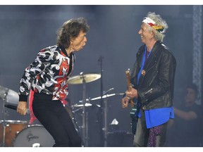 FILE - In this May 25, 2018 file photo, Mick Jagger, left, and Keith Richards, of The Rolling Stones, perform during their No Filter tour in London. The Rolling Stones will be rolling through the U.S. next year. The band says it is adding a 13-show leg to its tour in spring 2019, kicking off in Miami on April 20.