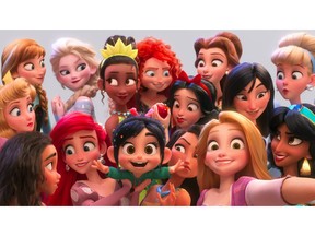 This image released by Disney shows the character Vanellope von Schweetz, voiced by Sarah Silverman, foreground center, posing for s selfie with Disney princesses in a scene from "Ralph Breaks the Internet." Filmmakers invited the original voice talent to return to the studio to help bring their characters to life. (Disney via AP)