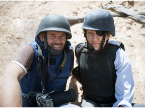 This image released by Arrow Media shows photographer Paul Conroy, left, with war correspondent Marie Colvin in Misrata, Libya. A new documentary recounts in searing detail the final days of Colvin, who was killed in shelling from Syrian President Bashar Assad's forces in 2012 in the city of Homs, where she was documenting civilian suffering.