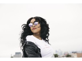 In this Aug. 13, 2018 photo, R&B singer Gabi Wilson, better known as H.E.R., poses for a portrait in New York. She is Apple Music's latest "Up Next" artist and ranks sixth among R&B artists on the streaming platform.