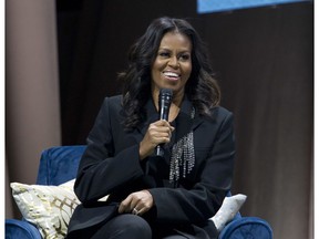 FILE - In this Nov. 17, 2018 file photo, former first lady Michelle Obama speaks to the crowd as she presents her anticipated memoir "Becoming" during her book tour stop in Washington. Crown Publishing tells The Associated Press on Wednesday that the former first lady's memoir has sold more than 1.4 million copies in all formats in the U.S. and Canada in the seven days since it was released Nov. 13.