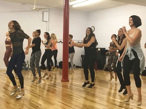 In this Sept. 19, 2018 photo, dancer Beth Nicely, left, teaches Pop Tap class, a weekly tap dance routine to pop music, in New York. Every Wednesday night, Broadway dancer Nicely spends her one night off a week from the musical "Chicago" leading a group of enthusiastic New Yorkers in a joyful ritual: Tap dancing.