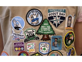 FILE - In this  June 18, 2018, file photo, patches cover the back of a Girl Scout's vest at a demonstration of some of their activities in Seattle. The Girl Scouts of the United States of America filed a trademark infringement lawsuit on Monday, Nov. 5, against the Boy Scouts of America for dropping the word "boy" from its flagship program in an effort to attract girls.