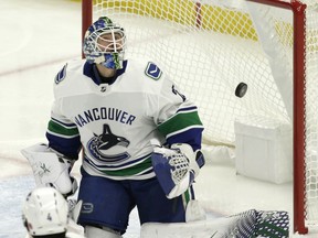 Vancouver Canucks goalie Jacob Markstrom (25) watches the puck during the first period of an NHL hockey game against the Buffalo Sabres, Saturday, Nov. 10, 2018, in Buffalo N.Y.