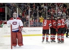 Montreal Canadiens goaltender Carey Price, left, stands near his net after allowing a goal to New Jersey Devils left wing Taylor Hall (9) during the second period of an NHL hockey game Wednesday, Nov. 21, 2018, in Newark, N.J.