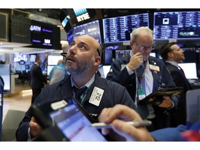 FILE- In this Friday, Nov. 9, 2018, file photo trader Vincent Napolitano, left, works on the floor of the New York Stock Exchange. The U.S. stock market opens at 9:30 a.m. EDT on Tuesday, Nov. 20.