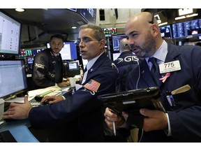 FILE- In this Oct. 26, 2016, file photo specialist Anthony Rinaldi, left, works with trader Fred DeMarco on the floor of the New York Stock Exchange. The U.S. stock market opens at 9:30 a.m. EDT on Thursday, Nov. 8.