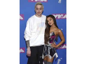 FILE- In this Aug. 20, 2018, file photo Pete Davidson, left, and Ariana Grande arrive at the MTV Video Music Awards at Radio City Music Hall in New York. Grande has released a song referencing her exes, including former fiance and "SNL" star Davidson and the late Mac Miller.