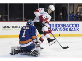 New York Islanders goaltender Thomas Greiss (1) makes a save against New Jersey Devils center Brian Boyle (11) during the first period of an NHL hockey game, Saturday, Nov. 3, 2018, in New York.