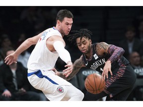 Los Angeles Clippers forward Danilo Gallinari (8) and Brooklyn Nets guard D'Angelo Russell (1) vie for a loose ball during the first half of an NBA basketball game, Saturday, Nov. 17, 2018, in New York.
