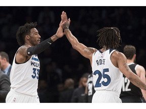 Minnesota Timberwolves forward Robert Covington (33) and guard Derrick Rose (25) celebrate after Covington scores a goal during the second half of an NBA basketball game, Friday, Nov. 23, 2018, in New York. The Timberwolves won 112-102.