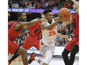 Syracuse's Tyus Battle, center, drives to the hoop past Eastern Washington's Kim Aiken, left, Luka Vulikic, back, and Jesse Hunt, right, in the first half during an NCAA college basketball game in Syracuse, N.Y., Tuesday, Nov. 6, 2018.