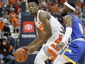 Syracuse's Tyus Battle, left, looks to pass the ball while being guarded by Morehead State's A.J. Hicks, right, during the first half of an NCAA college basketball game in Syracuse, N.Y., Saturday, Nov. 10, 2018.