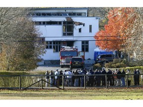 FILE - In this Nov. 21, 2018 file photo, authorities gather in Colts Neck, N.J., to investigate the aftermath of fatal fire that killed two children and two adults. The bodies of Keith Caneiro, his wife Jennifer Caneiro, their children Jesse, 11, and Sophia 8, were found at the scene: all victims of an apparent homicide.
