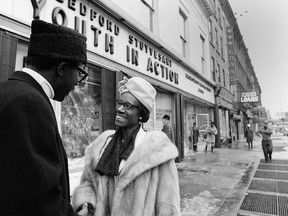FILE- In this Dec. 20, 1968, file photo, New York Assemblywoman Shirley Chisholm talks with a constituent in the Bedford-Stuyvesant neighborhood in the Brooklyn Borough of New York. Chisholm's election to Congress was the start of a national political career in which she fearlessly and relentlessly stood up and spoke out for causes like civil and women's rights and which included, just four years after her first federal win, a run for president.