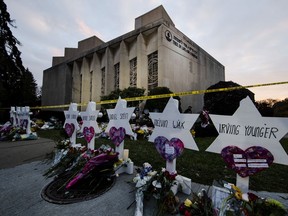 FILE - In this Oct. 29, 2018, file photo, a makeshift memorial stands outside the Tree of Life synagogue in the aftermath of a deadly shooting at the in Pittsburgh. A moment of silence to honor the 11 people killed in the synagogue shooting is planned for a downtown Pittsburgh park, on Friday, Nov. 9.